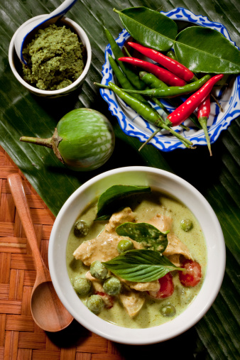 Thai Green Curry With Chicken & Fresh Ingredients As Garnishing.