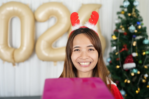 Merry Christmas 2024 concept Asian women are happy and delighted to receive Christmas gifts.