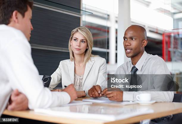 Team Of Three Discussing Business Plans In Meeting Stock Photo - Download Image Now - Business, Contrasts, Corporate Business