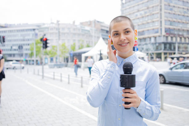 istock Young TV reporter broadcasting live 1833822725