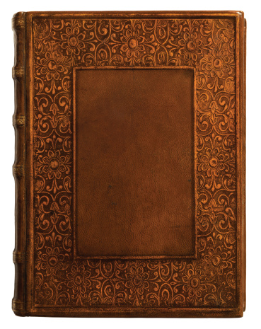 Centuries old leather book with intricate border.