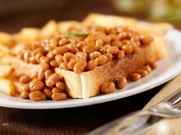 Baked Beans on Toast Baked Beans on Toast with French Fries-Photographed on Hasselblad H3D2-39mb Camera Beans on Toast stock pictures, royalty-free photos & images