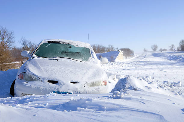 Car slid off the road due to winter driving conditions.