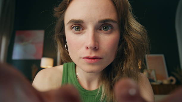 istock Attentive girl reading device home web camera view. Surprised lady face amazed 1833832548