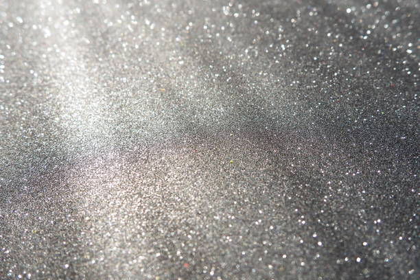 istock Oblique rays of light on a black surface. Bokeh, dust particles, reflection and magical glow. Festive shining background. New Year, Christmas, birthday. Plastic card design. Cosmic photons from space 1833832567