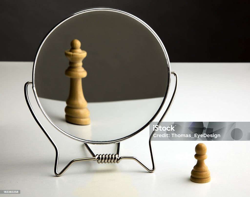 Chess Pawn Imagining Itself as a Queen. Lowly Chess Pawn standing in front of mirror envisioning itself as a Queen. Mirror - Object Stock Photo