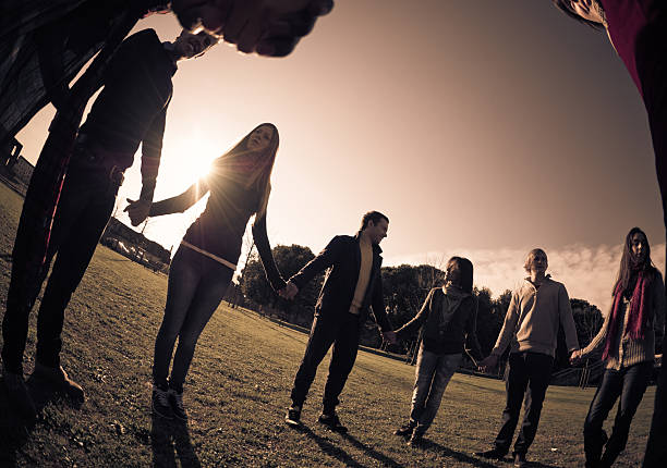 istock Friends Holding Hands in a Circle Outside 183384218