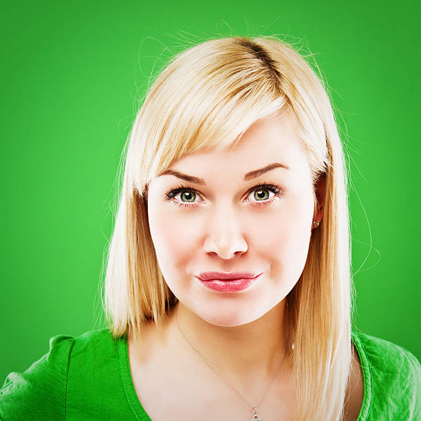 istock Hesitant woman isolated on clear green 183384716
