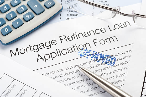 istock Approved Mortgage Refinance Application Form with pen, calculato 183384736