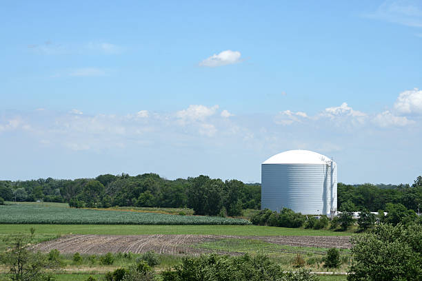 Storage Tank "Storage tank for gas, oil, soybean oil, etc. in Indiana, USA. Blue sky with clouds and green farmland surround the tank." ammonia fertilizer stock pictures, royalty-free photos & images