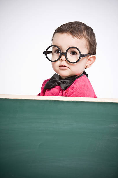 istock Little girl  behind a chalkboard. 183386912