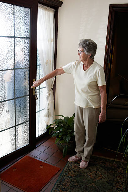 istock Senior lady at the front door 183386928