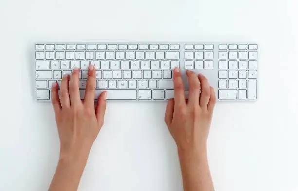 Photo of typing on keyboard.