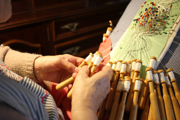 istock elderly woman creating bobbin lace at home at night 1833891030