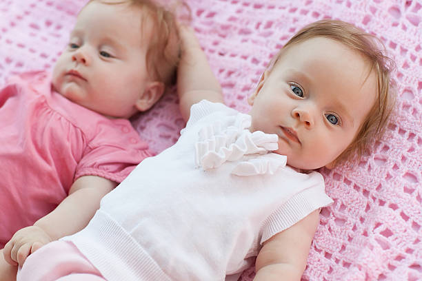 istock Sweet little  twins lying on a pink blanket. 183389727