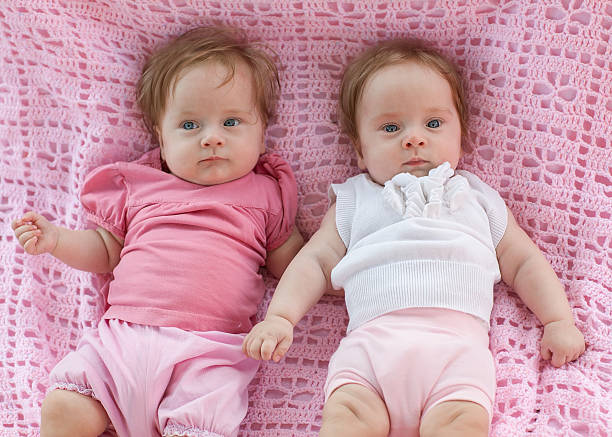 istock Sweet little  twins lying on a pink blanket. 183389878