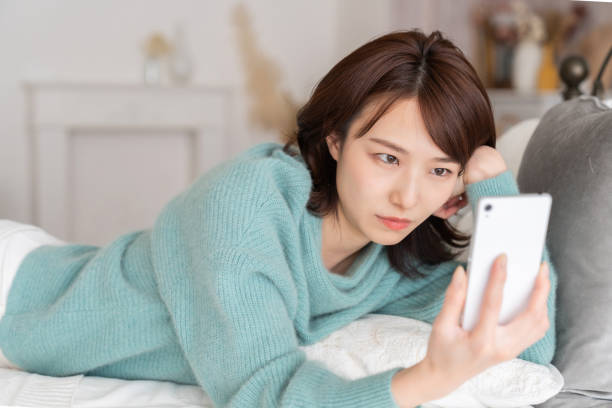 istock Asian woman using a smartphone,think, 1834051816