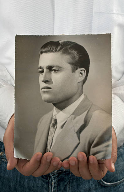 istock Man Holding His Father's Old Photo 183405866