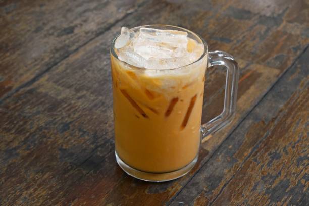 istock Thai iced milk tea serving on wooden table. 1834059010