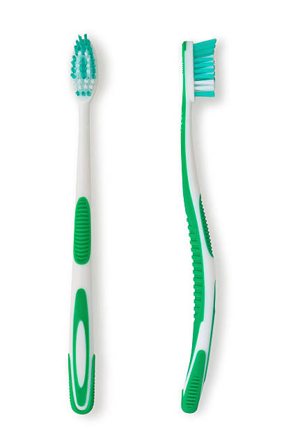 Two identical toothbrushes in differ positions Green toothbrushes isolated on white. toothbrush stock pictures, royalty-free photos & images