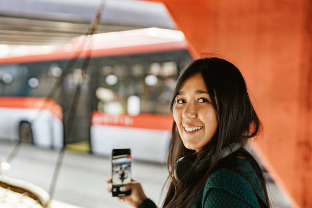 Latina woman smiling at the bus stop
