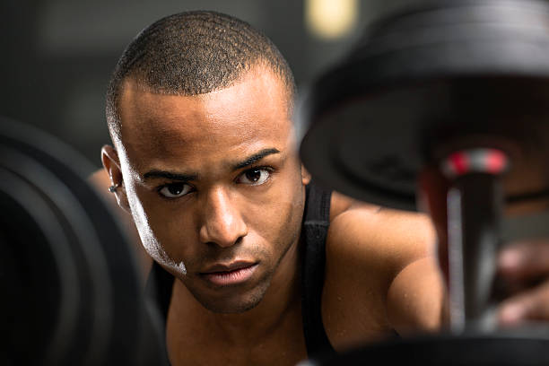 istock Young Man Reaching for a Dumbbell 183407757