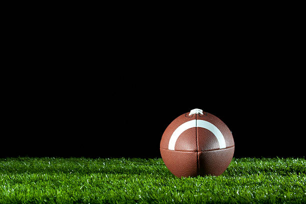 istock Gridiron ball on the grass at night. 183408189