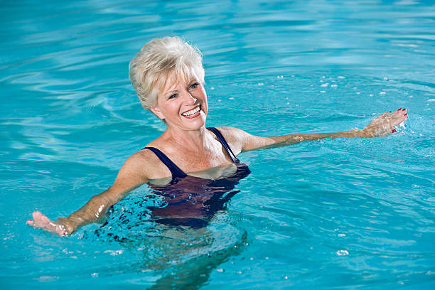 istock Active senior woman in swimming pool 183408347