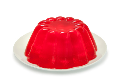 A red jello (jelly in the UK) isolated on a white background.