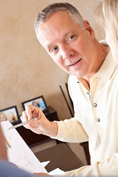 istock Financial Advisor Discussing Finances With Couple At Their Home 183409070