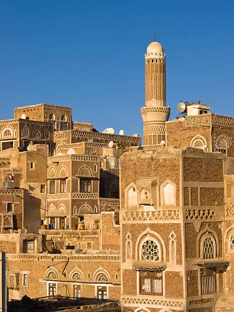 "Beautiful houses and minarets in old city in Sanaa in the evening, high angle view. Yemen."