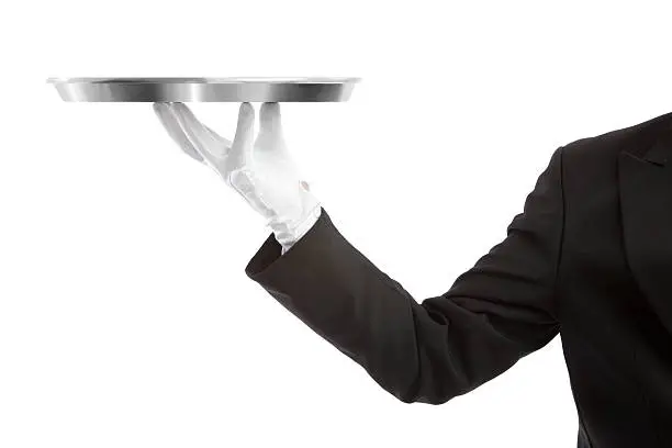 Waiter holding a tray and looking at the camera