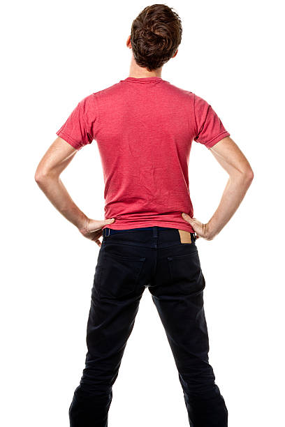 Rear View Of Young Man With Hands On Hips Portrait of a man on a white background. ass boy stock pictures, royalty-free photos & images