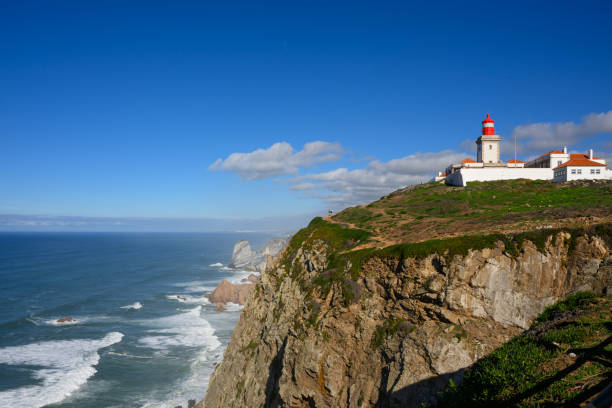 istock Big waves rush to the cliffs under the lighthouse at Cabo da Roca, Portugal 1834100971