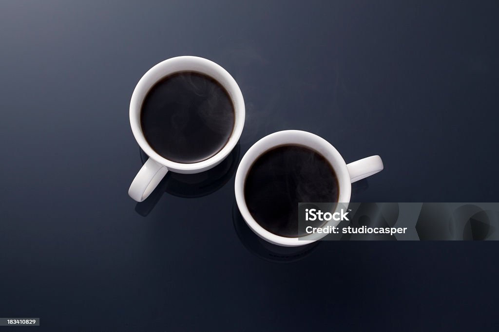 Hot coffee in two white mugs on black Cup of　tow hot coffee　 Two Objects Stock Photo