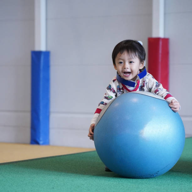 Child playing with a big ball