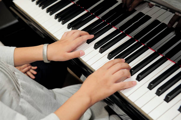 istock Woman playing the piano 1834110560