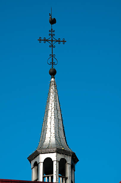 istock Steeple with rooster weather vane and cross 183411495