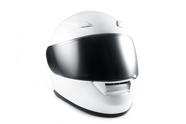 White motorcycle helmet with black visor on white background stock photo