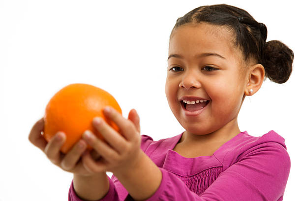istock Little Girl Looking At an Orange 183412336