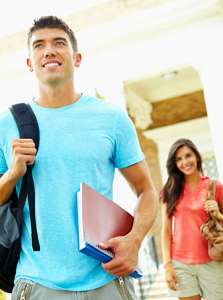 istock Young man with books and backpack at college campus 183412872