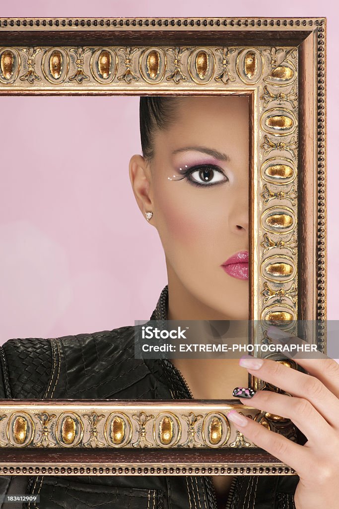 Real Framed Beauty "Decorative art frame and a gorgeous girl hiding half of her face, exposing her fashion makeup. THIS PHOTO IS AVAILABLE ONLY ON ISTOCKPHOTO." Adult Stock Photo