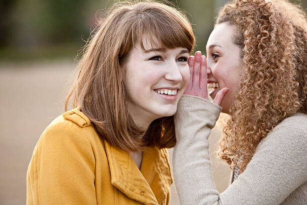 istock Teenage friends sharing secret 183413408