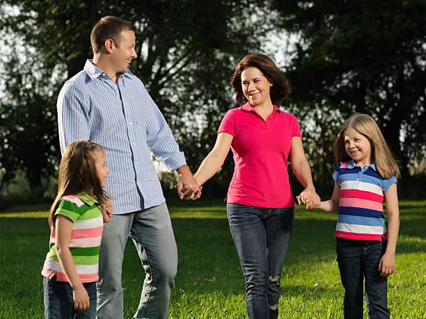 istock Family walking in the park holding hands 183413436