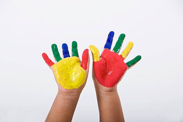istock Child's hands covered with colorful paint 183413449