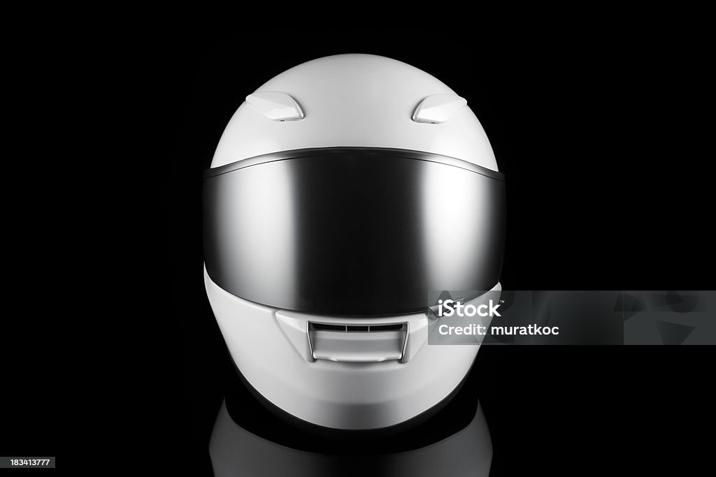 White Motorcycle Helmet white helmet on black background. Black Background Stock Photo