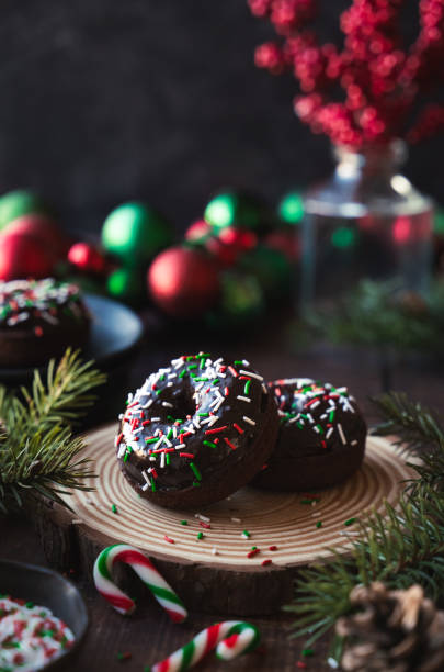 istock Close up of chocolate donuts surrounded by Christmas decorations. 1834143184