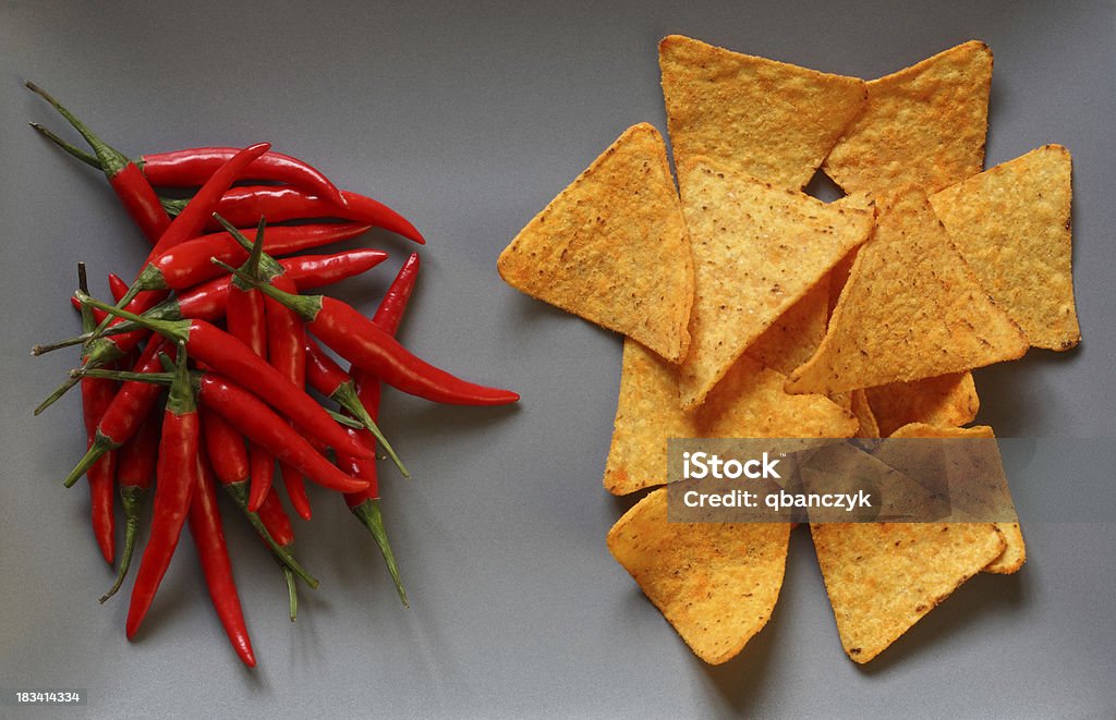 Chili Peppers with tortilla chips. Red chili peppers with tortilla chips on a plate. Chili Pepper Stock Photo