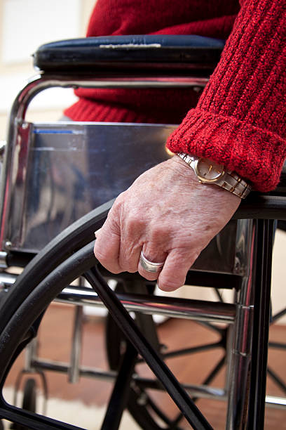 istock Senior woman's hand on wheelchair. 183414712