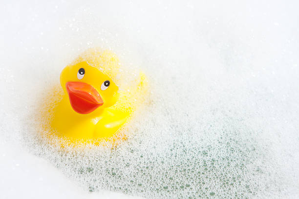 istock A vibrant yellow rubber duck floating in a bubble bath 183414816